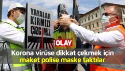 Korona virüse dikkat çekmek için maket polisin ağzına maske taktılar